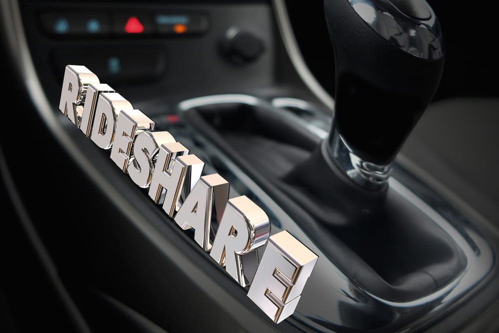 Rideshare concept displayed inside a vehicle representing Uber and Lyft driver status and insurance coverage phases in Florida