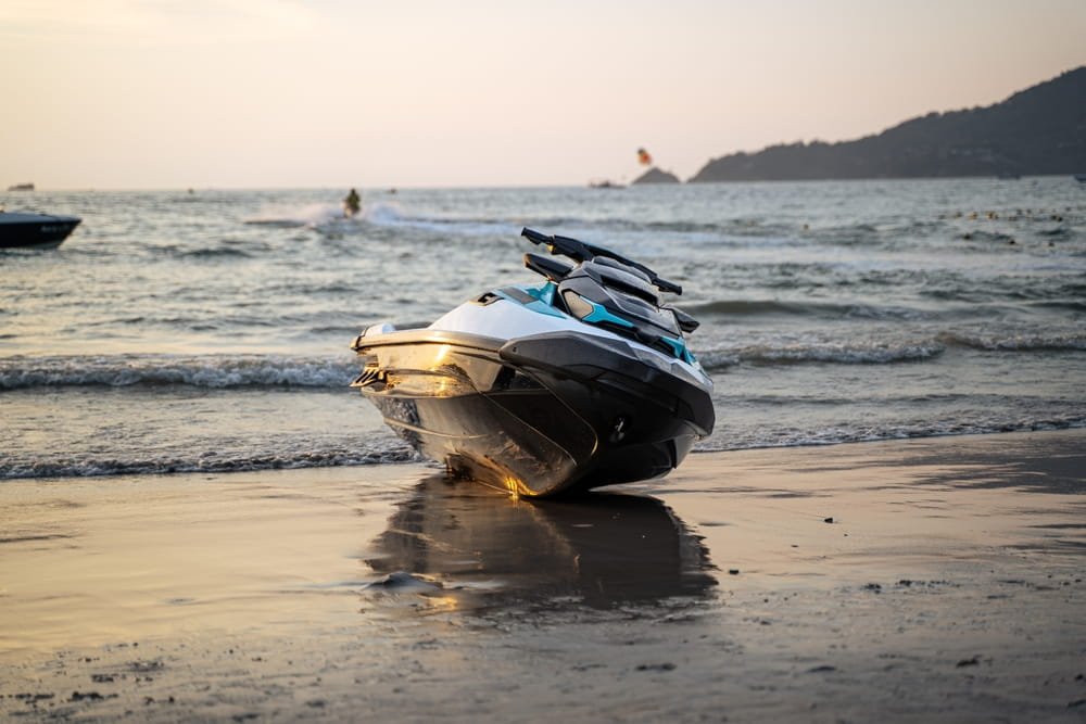 Jet ski sitting on the beach in rough Florida waters near Fort Lauderdale representing the dangers of jet ski accidents and resulting in possible liability claims